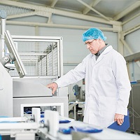 A man using a food manufacturing digital display
